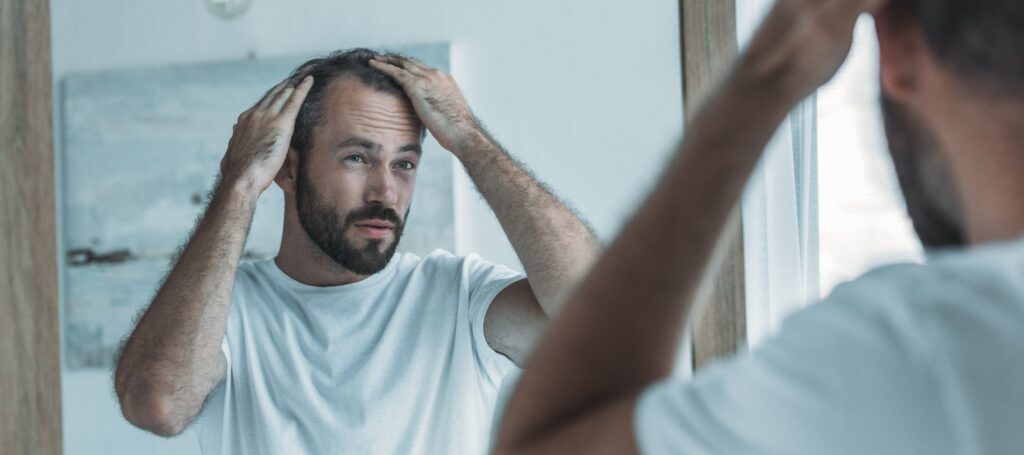 A man looking at himself in the miirror