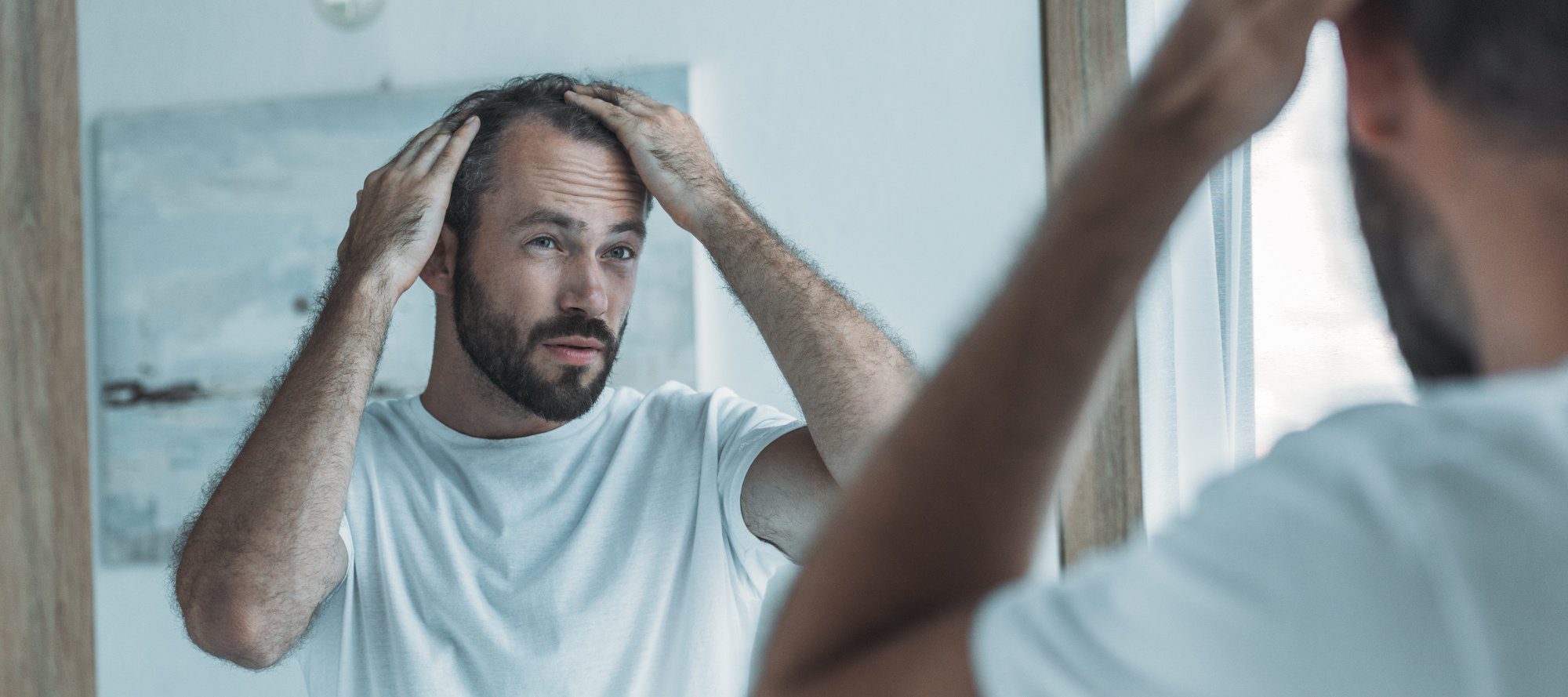 A man looking at himself in the miirror