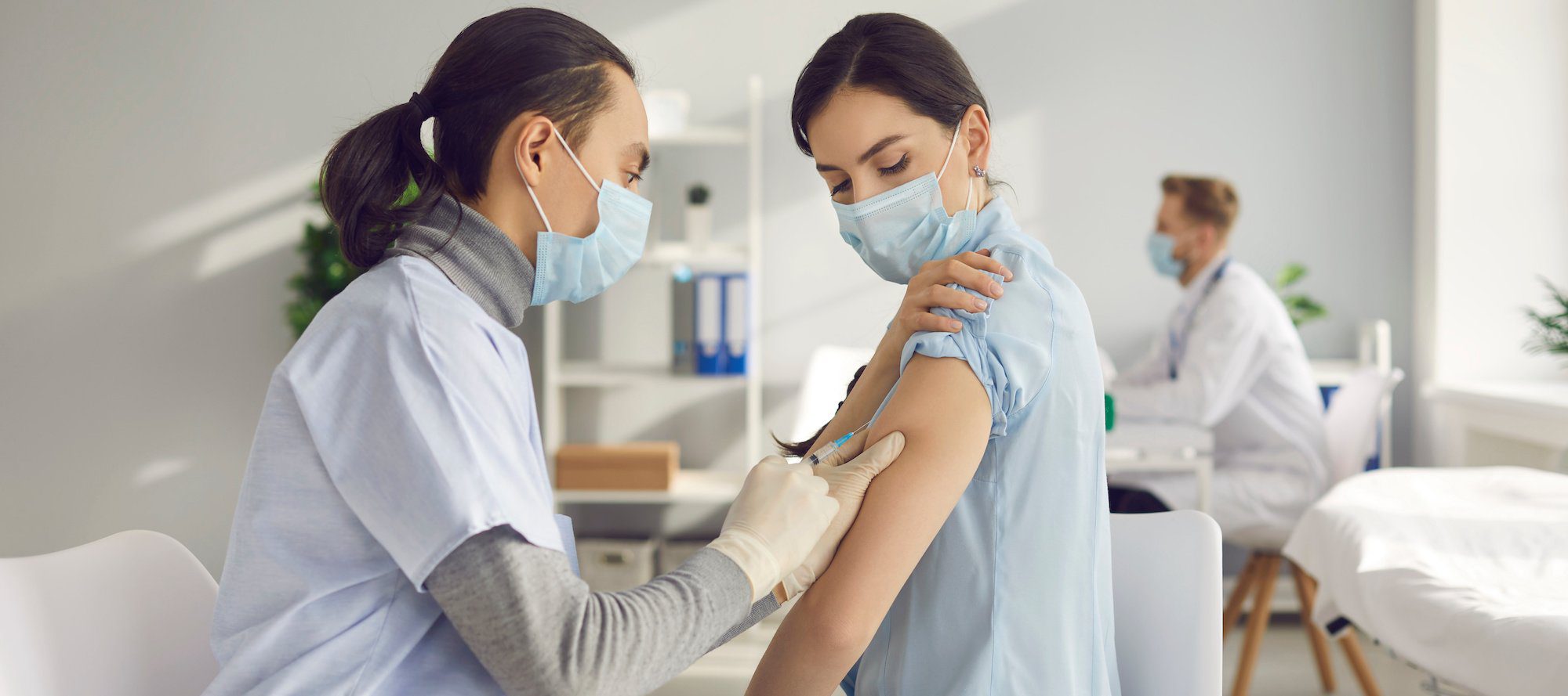 Young woman gets vaccinated at clinic or health center.
