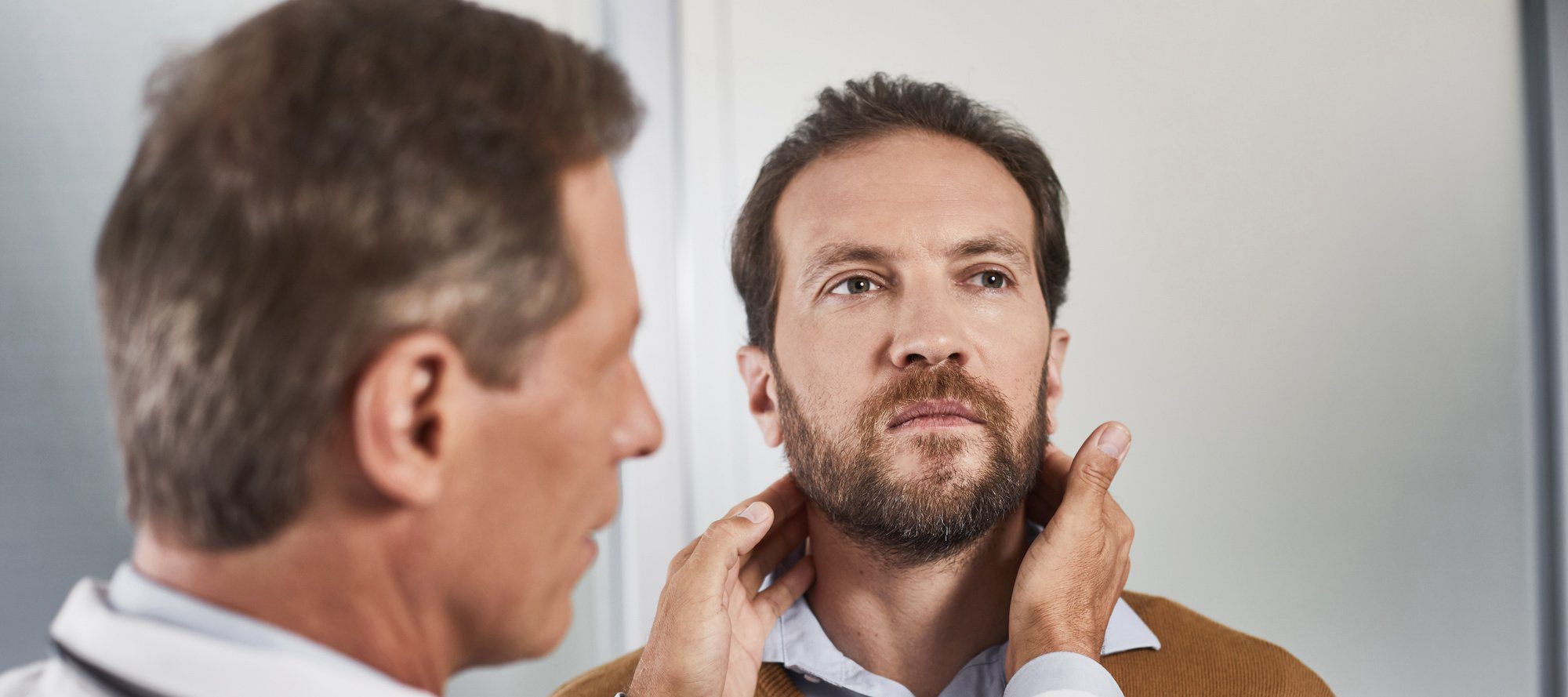 doctor checking mans Swollen lymph nodes